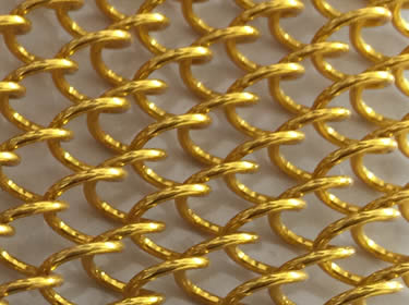A piece of stainless steel coil drapery mesh in golden color