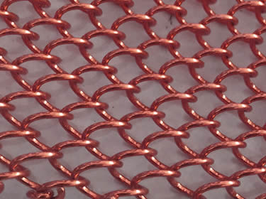 A piece of coil drapery wire mesh in red color