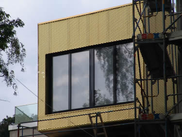 A building is covered by the yellow color aluminum expanded metal.
