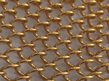A piece of bronze coil drapery mesh