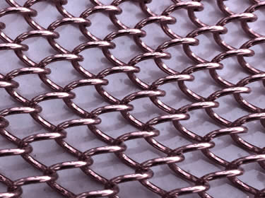 A piece of coil drapery mesh in dark purple color