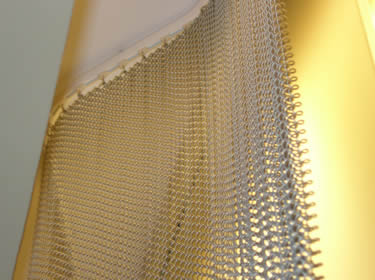 Stainless steel wire coil mesh for wall decorations looked resplendent in the soft light.