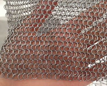 A piece of chain braid ring mesh on one woman's hand