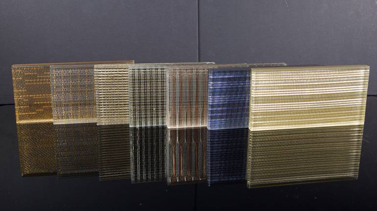 Several different laminated glass wire mesh on the table.